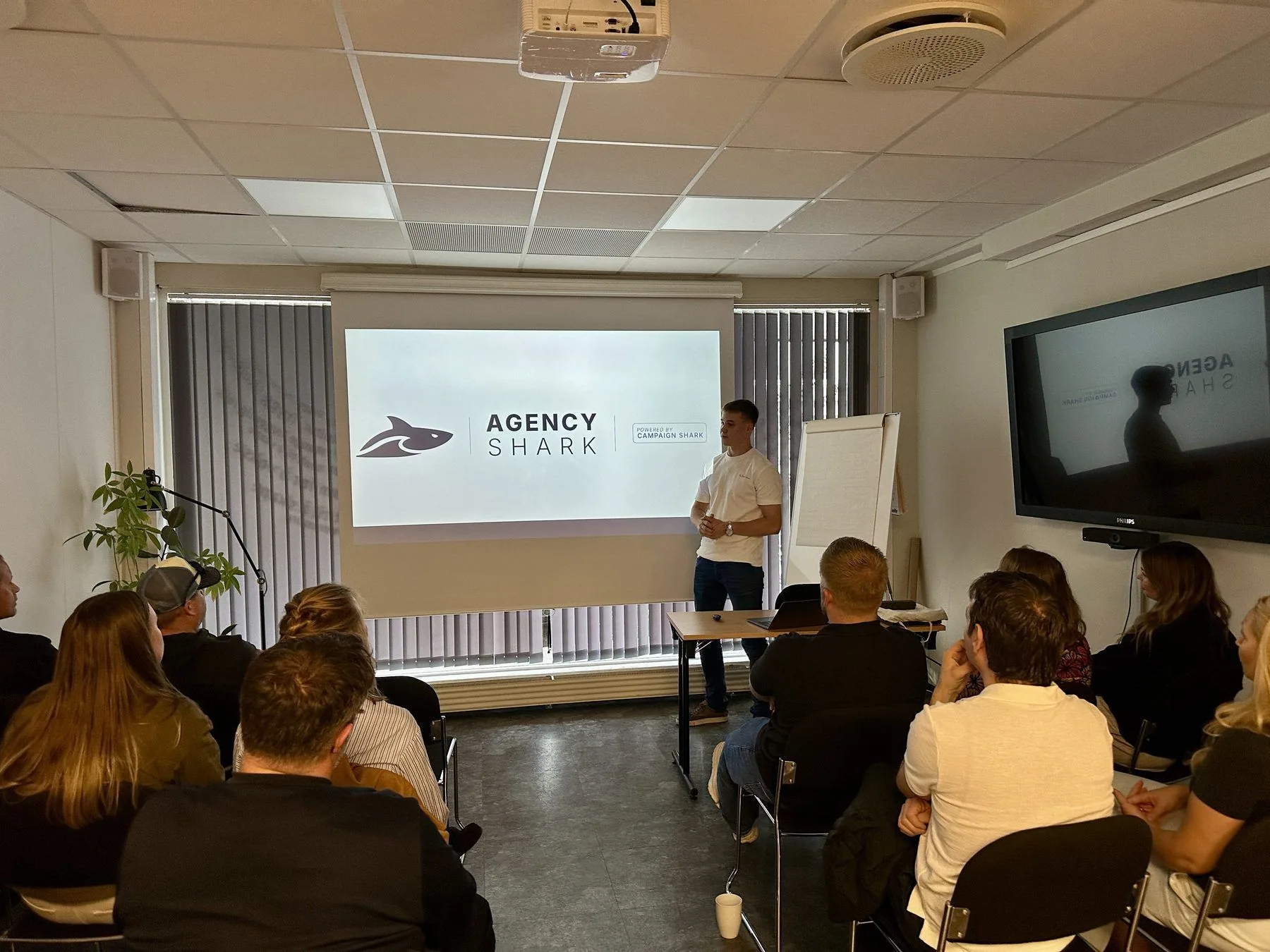 Adrian Siggerud giving a talk to a packed room of local businesses